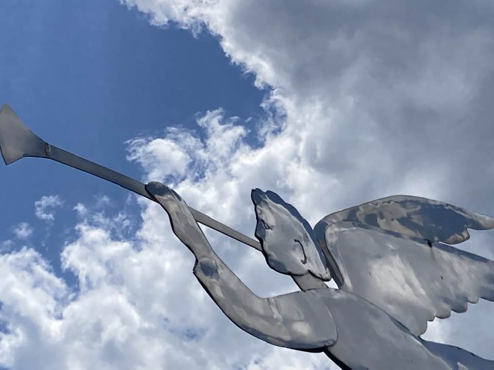 Metal angel sculpture against the sky